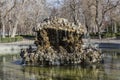 Original stone fountain with an irregular shape that is located in the Retiro park