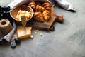 Original tasty French croissants with cheese and grapes on the wooden table. buttery flaky viennoiserie bread roll distinctive