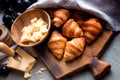 Original tasty French croissants with cheese and grapes on the wooden table. buttery flaky viennoiserie bread roll distinctive Royalty Free Stock Photo