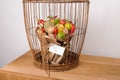 The original unusual edible vegetable and fruit bouquet with card in bird cage Royalty Free Stock Photo