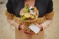 The original unusual edible vegetable and fruit bouquet with card in woman hands