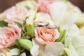 Original wedding rings on beautiful white roses wedding bouquet