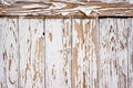 Original white painted boards of the old textured wall. Cracks in the old paint