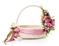 Original wicker basket with a beautiful, delicate pink decor with a pink ribbon around the basket. On a white background