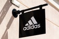 Orihuela Costa, Alicante, Spain - April 12, 2023: Adidas logo sign on wall of Adidas store. Adidas is multinational