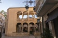 Orihuela, Spain - November 16, 2019: Street with old houses and lanterns overlooking the Cloisters of the Holy Cathedral of El