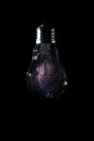 Orion Nebula inside of light bulb on dark background Royalty Free Stock Photo
