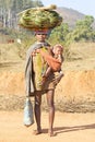 Orissan tribal woman carryng leafs and baby Royalty Free Stock Photo