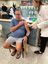 A senior man getting a flu shot before the flu season starts at a Publix grocery store pharmacy