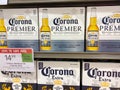 A display of boxes of bottles of Corona Extra and Corona Premier on a display shelf of a Publix Grocery Store
