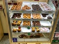A display case of tasty donuts at a Wawa restaurant and gas station