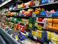 The fresh cheese aisle of a Sams Club Wholesale grocery store with a variety of fresh cheeses ready to be purchased by consumers