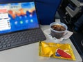 A drink and snack in front of a computer from a flight on Southwest Airlines Co