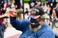 Orlando, FL, USA - JUNE 19, 2020: Bearded man in a cap of the US Army in protest, fist up. Fight. Masked old man