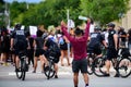 Orlando, FL, USA - JUNE 19, 2020: Police and demonstrators. Protest against police actions. Young man showed finger to a