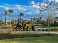 A landscape worker and his Catapillar 908M wheel loader working on community landscaping from the Brightview Landscaping company