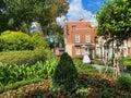 Mary Poppins standing in a garden in the England area of the World Showcase in EPCOT