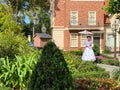 Mary Poppins standing in a garden in the England area of the World Showcase in EPCOT