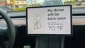 A Tesla set on dog mode to keep the air conditioning on for the car owners canine companion while they are parked in a parking lot Royalty Free Stock Photo