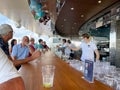 Bartenders serving drinks at an outdoor bar on the MSC Cruise Ship Divina