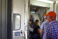 People waiting on a jetway to board an airplane