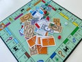 Pieces for the game Monopoly by Hasbro on a white background.  Concept business Royalty Free Stock Photo