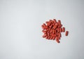 A pile of red tablet medication in pill form