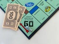 The race car on the Passing Go square for the game Monopoly by Hasbro on a white background