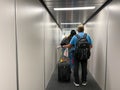 A man walking in the jetway to board an airplane at an airport