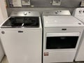 A set of Maytag washer and dryer machines at a Home Depot retail store