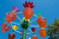 Parents and kids enjoying colorful flower pots aboard AbbyÃ¢â¬â¢s Flower Tower on lightblue sky background at Seaworld in Internatio