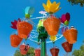 .Parents and kids enjoying colorful flower pots aboard AbbyÃ¢â¬â¢s Flower Tower on lightblue sky background at Seaworld in Internati