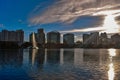 Colorful buildings and beautiful sunset with sun reflected in lake in Orlando Downtown area.