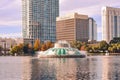 Colorful vintage fountain , business buildings and autumn trees at Lake Eola Park in Orlando Downtown area 1 Royalty Free Stock Photo