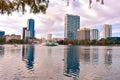 Colorful vintage fountain , business buildings, swan boats and autumn trees at Lake Eola Park in Orlando Downtown area 2 Royalty Free Stock Photo