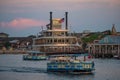 Paddlefish restaurant and taxi boats sailing in Disney Springs at Lake Buena Vista.