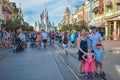 Family posing for a photo on Main Street in Magic Kingdom at Walt Disney World .