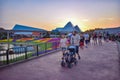 People walking in Epcot theme park on sunset background at Walt Disney World . Royalty Free Stock Photo