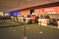 Woman checking luggage in Avianca Airlines counter at Orlando International Airport .