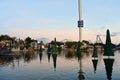 Christmas Trees over the lake, sky tower and colorful rollercoaster on sunset background in International Drive area. Royalty Free Stock Photo