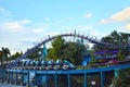 People having fun rollercoaster ride on bluelight sky background in International Drive area.