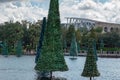 Partial view of Shamu Stadium and Christmas trees on lake at Seaworld