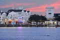 People enjoying Boardwalk on beatiful sunset background at Lake Buena Vista.