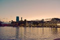 Taxi boat, colorful hotel and iluminated villas on sunset background, at Lake Buena Vista.