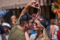 Romantic couple kissing and making a heart with their hands at Magic Kigndom 2