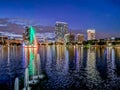 ORLANDO, FLORIDA, USA - DECEMBER, 2018: Colorful lights, after sunset, at Eola Lake Park with the fountain and the buildings