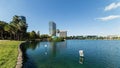 Orlando Lake Eola in the morning with urban skyscrapers and clear blue sky.