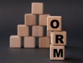 ORM - acronym on wooden cubes on a dark background