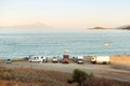 Ormos Panagias, Greece, 27/06/2019: Recreational vehicles parked on the beach. Camper lifestyle