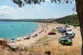 Ormos Panagias, Greece, 29/06/2019: Warm summer day on the beach by the sea. People enjoying warm weather on the beach and in